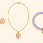 Illustrated pink flower earrings, a strawberry pendant necklace, and a lavender beaded bracelet with a star charm.
